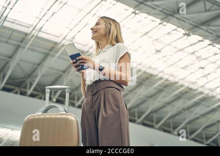 Positive delighted young female looking at monitor Stock Photo