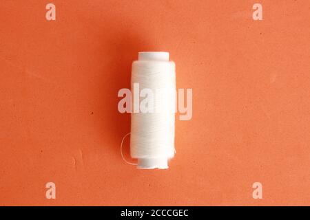 Closeup shot of a white sewing thread roll Stock Photo