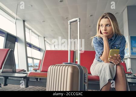 Serious young female being deep in her thoughts Stock Photo
