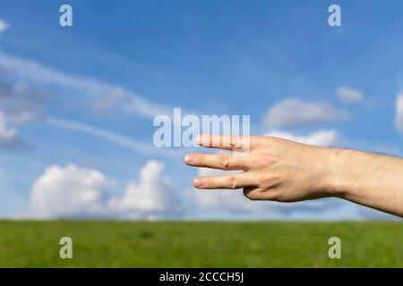 Man hand show the number three on the nature background Stock Photo
