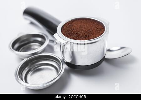 Espresso holder and replaceable coffee filters. The horn from the coffee machine on a white background. Selective focus. High quality photo Stock Photo