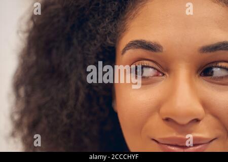 Pleasant attractive female looking away with positivity Stock Photo