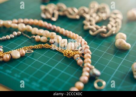 White and pink pearls isolated on green background Stock Photo