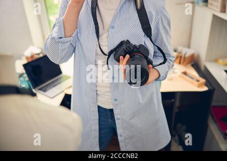 Caucasian woman with professional shooting device in hand Stock Photo