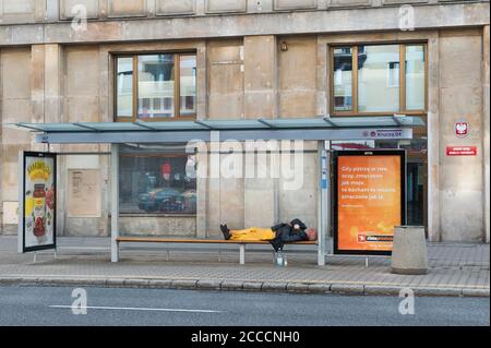 Homeless sleeping on a bus stop, Warsaw, Poland Stock Photo