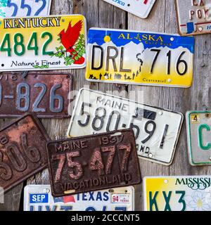 Bar Harbor, Maine, USA - August 28 2014: Old car license plates on a wall in Bar Harbor. In the United States, each jurisdiction has a unique design, Stock Photo