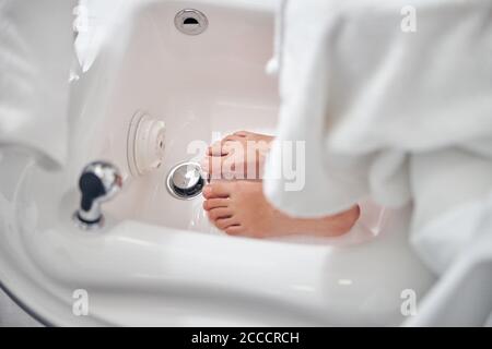 Woman preparing for pedicure in beauty salon Stock Photo