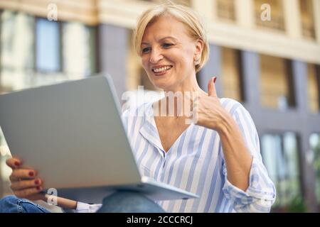 High-spirited Caucasian woman showing a gesture of approval Stock Photo