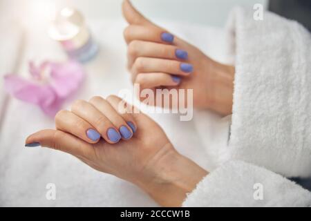 Woman rejoicing at work of nail artist Stock Photo