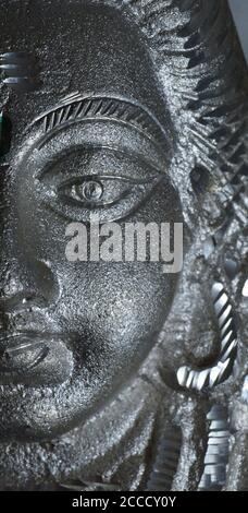 metal face of Lord Shiva's statue. Shiva is known as The Destroyer within the Trimurti, the Hindu trinity that includes Brahma and Vishnu. In Shaivism Stock Photo