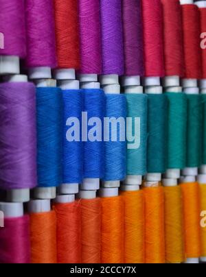 colourful thread rolls arranged in a box. Some parts of the image are ...