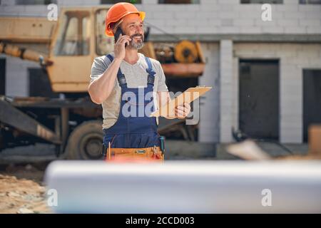 Cheerful mature man calling on his smartphone Stock Photo