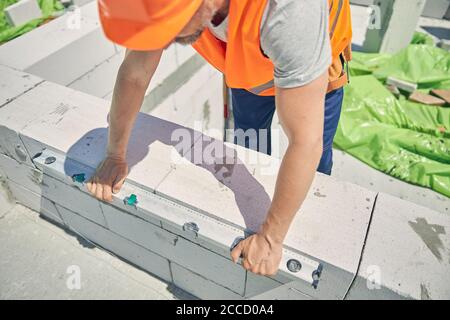 Builder checking the degree of levelness with a spirit level Stock Photo