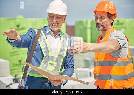 Caucasian male engineers staring into the distance Stock Photo