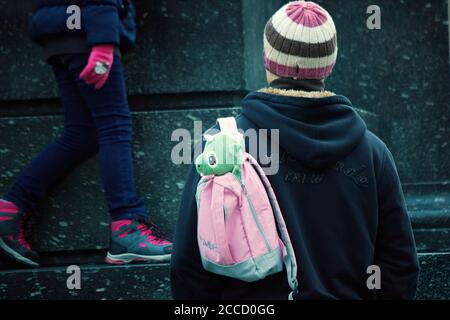 Krakow, Poland - December 23, 2014: A man carrying a bag carrying dragon soft toy souvenir from cracow bought during christmas eve in winter holiday b Stock Photo