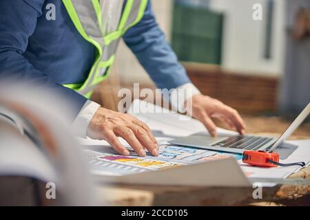 Senior male worker using his laptop outdoors Stock Photo