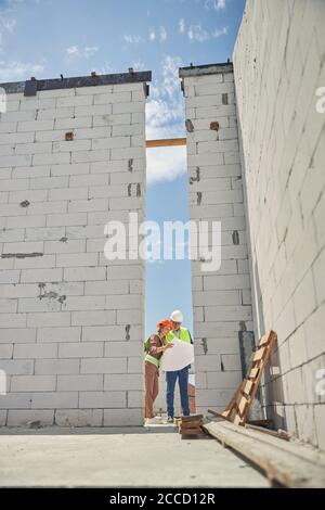 Two joyous civil engineer working together outside Stock Photo