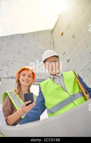 Senior constructor and a contractor posing for the camera Stock Photo