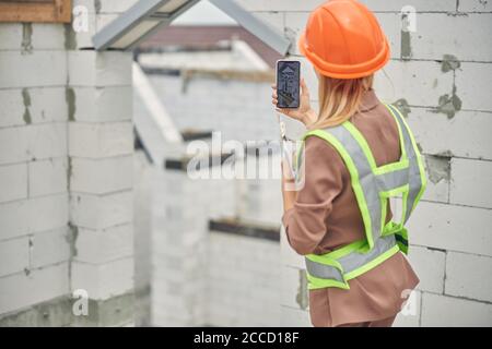 Civil engineer using her cellphone at work Stock Photo