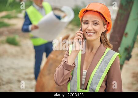 Cheerful lady calling on her cellular phone Stock Photo