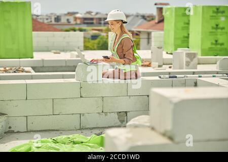 Female engineer writing an email on her laptop Stock Photo