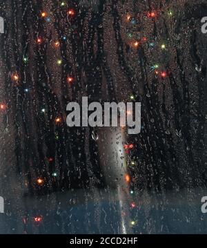 raindrops on the window with bokeh lights Stock Photo
