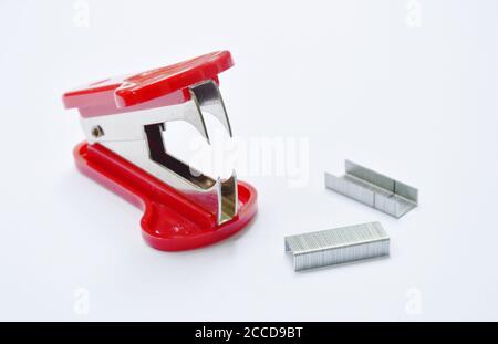 red staple remover and refill on white table Stock Photo