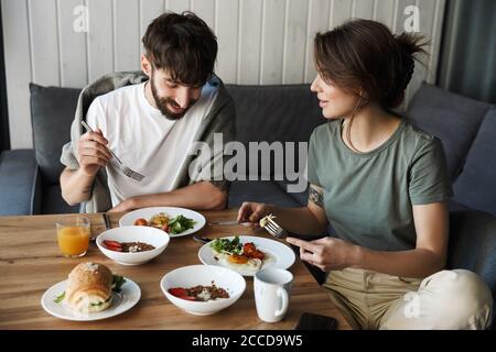 Lovely young couple having healthy breakfast in the kitchen Stock Photo
