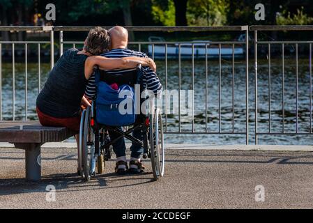 Old Man in a Wheelchair, Old Man on Riverside, Old Man and his Daughter on Riverside Stock Photo