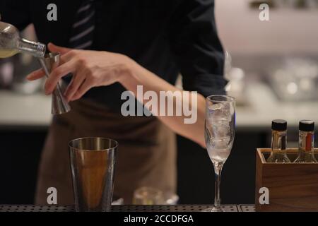 bartender making cocktail in bar counter. blur background Stock Photo