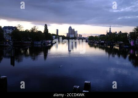 Beautiful morning light in the center of Amsterdam with the skyline of the south of Amsterdam over the Amstel river Stock Photo