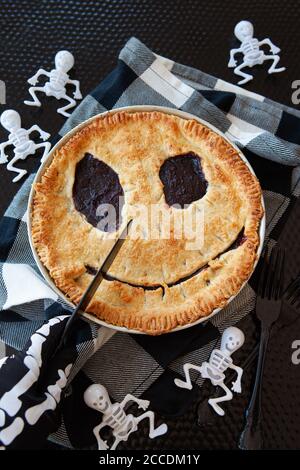 Homemade cherry pie with a scary face for Halloween Stock Photo