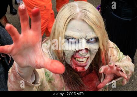 World Zombie Day Walk participants as zombies in costumes and make up walking through London, England, UK Stock Photo