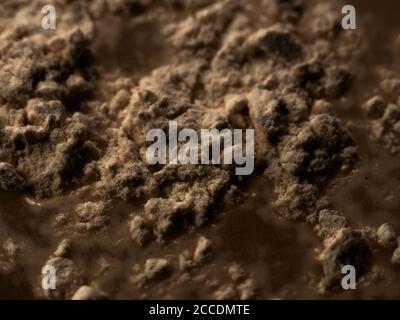 Abstract surface - rugged and rough heap and mound of brown dark substance. Stock Photo