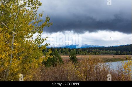 An early morning storm clearing over the Teton mountains during Autumn in Grand Teton National Park Stock Photo