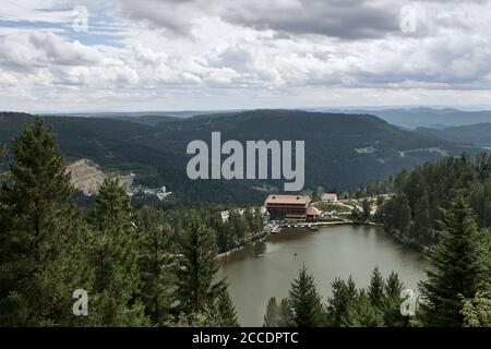 Scenic view over Lake Mummelsee with forested mountain slopes in Seebach, Black Forest, Germany Stock Photo