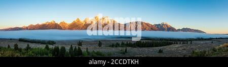 A panorama view of the Teton mountains in early morning light in Grand Teton National Park Stock Photo