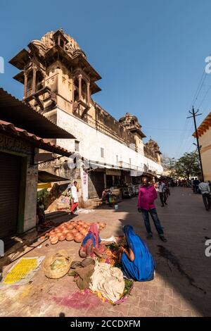 Orchha, Madhya Pradesh, India - March 2019: Indian women street vendors below an ancient temple in the village of Orchha. Stock Photo