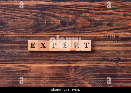 Expert word written on wood block. Business concept Stock Photo