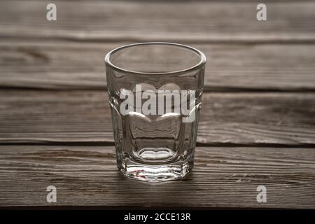 Empty glass standing on a wooden table Stock Photo