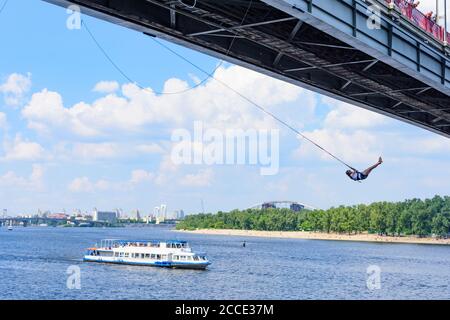 Kiev (Kyiv), bungee jumping, river Dnipro (Dnieper), Parkovy (Pedestrian) Bridge to Trukhaniv Island, passenger ship in Kyiv, Ukraine Stock Photo