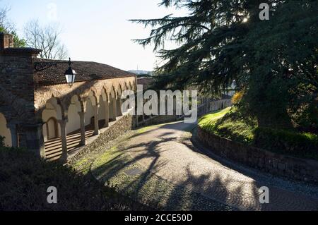 The ascent of the hill leading to the castle of Udine, Italy, in the late afternoon light Stock Photo