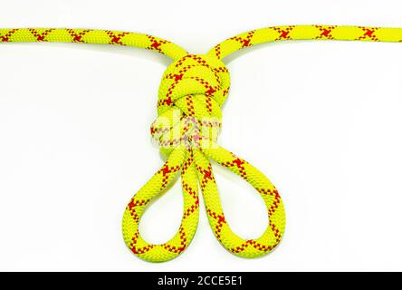 double figure eight 8 knot or Flemish loop or bunny ears use for climbing or equalizing anchors in alpinistic. Stretched colored, green rope for Stock Photo