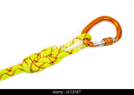 double Flemish loop or figure eight 8 knot with new colored aluminum carabiner. equipment use for attaching rope to climbing harness and create a Stock Photo