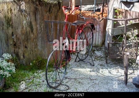 Iron vintage bicycle model. Garden decoration.Flowerpot stand.Metal artwork. Stock Photo