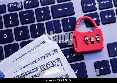 Combination lock with dollars on keyboard Stock Photo