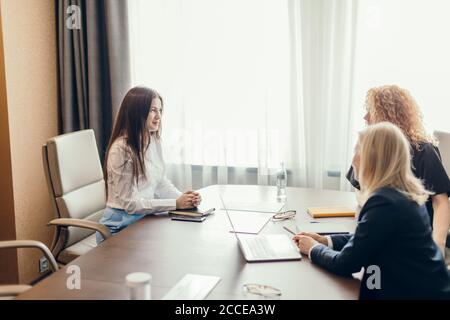 Two female human resources managers conducting job interview with woman applicant in office. Getting a new job concept Stock Photo