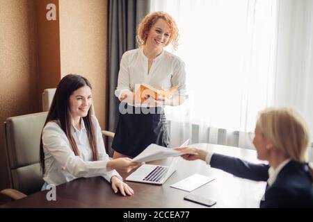 Two female human resources managers conducting job interview with woman applicant in office. Getting a new job concept Stock Photo