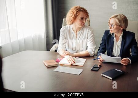 Two female human resources managers conducting job interview with woman applicant in office. Getting a new job concept Stock Photo