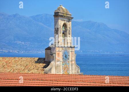 the facade of a medieval church in the historic center of gaeta and in the background the sea and the mountains of the homonymous gulf Stock Photo